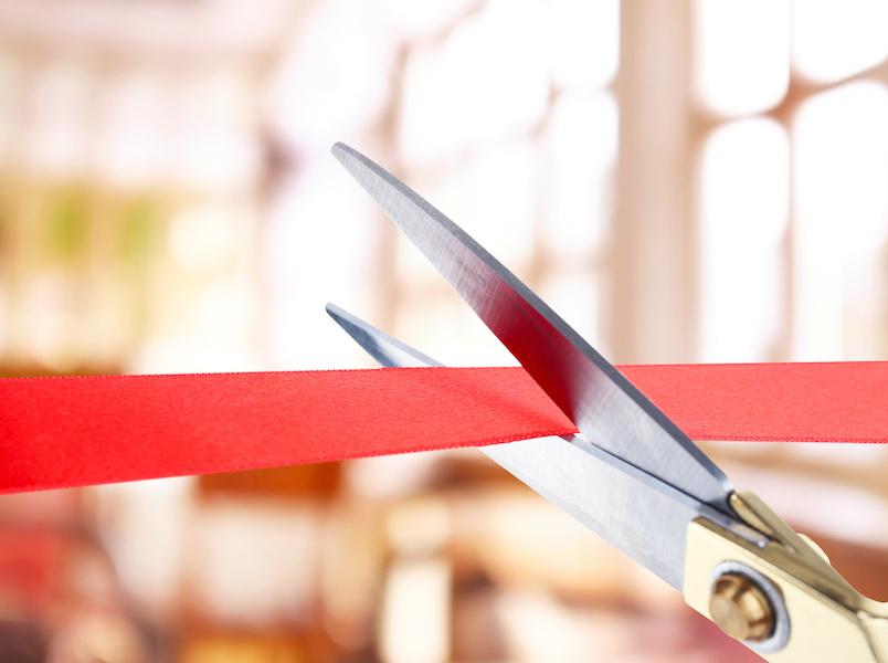 Grand opening, cutting red ribbon