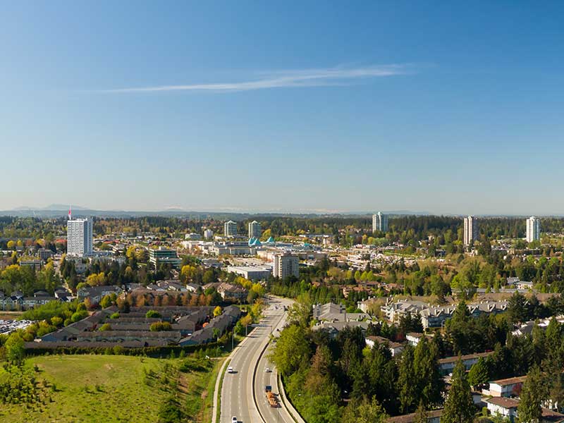 Aerial panoramic view of a residential neighborhood near Guildford Centre Mall during a sunny morning. Taken in Surrey, Vancouver, BC, Canada.