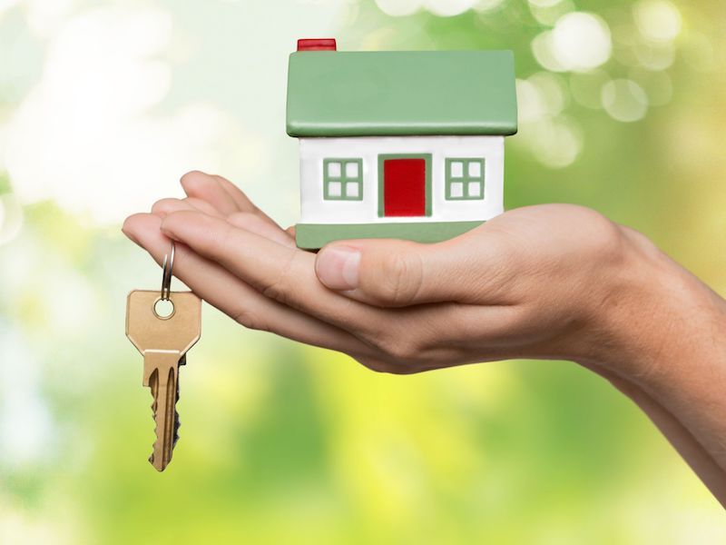 Hand holding home buying house