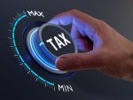 Tax reduction and deduction for businesses and individuals. Concept with hand turning knob to low taxation rate. Return form, exemptions, incentives.